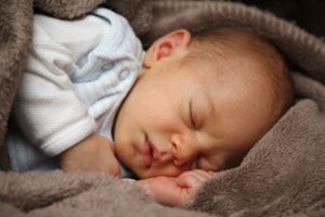 baby sleeping on brown blanket sleep options newborn infant