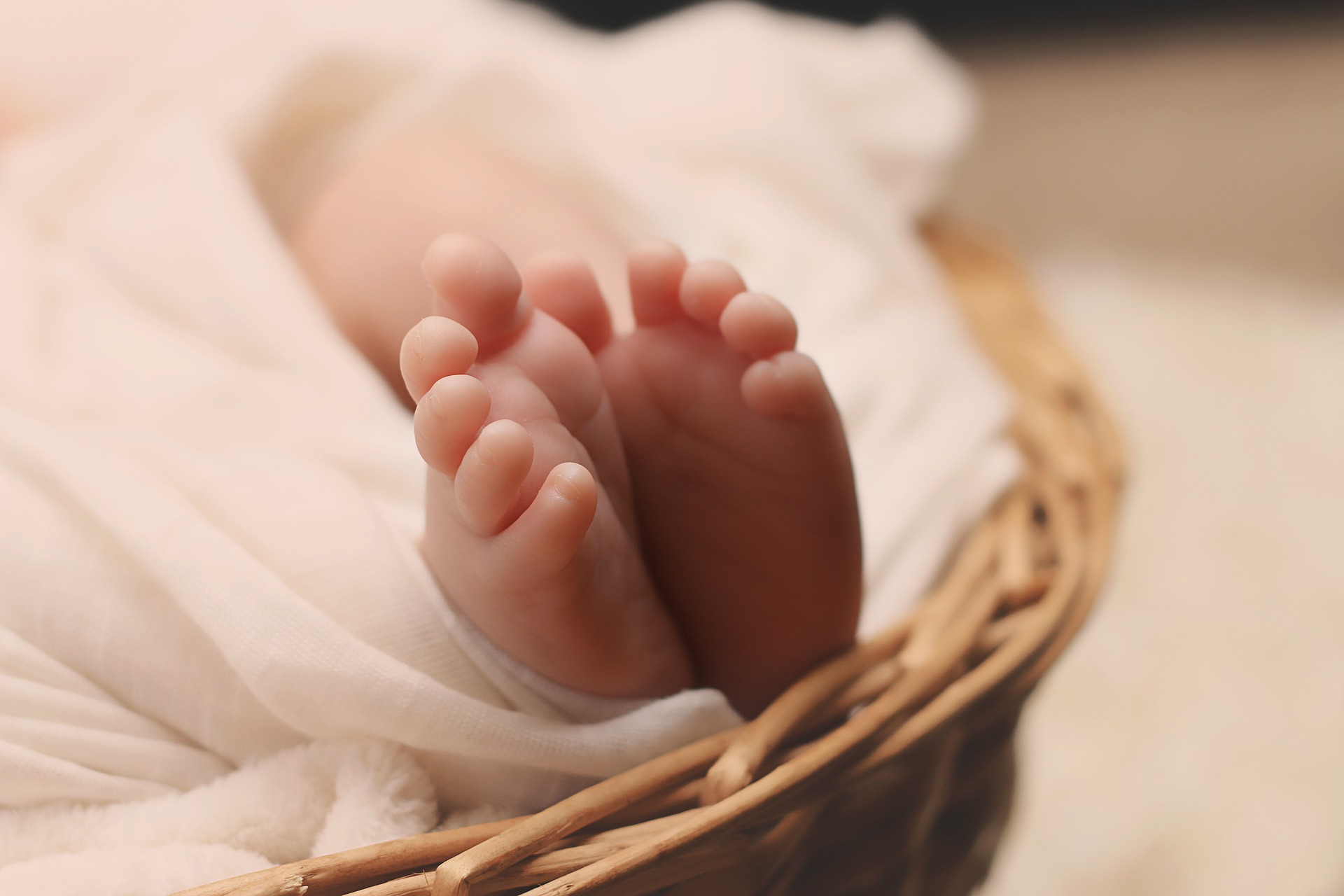baby feet shot sleeping in basket